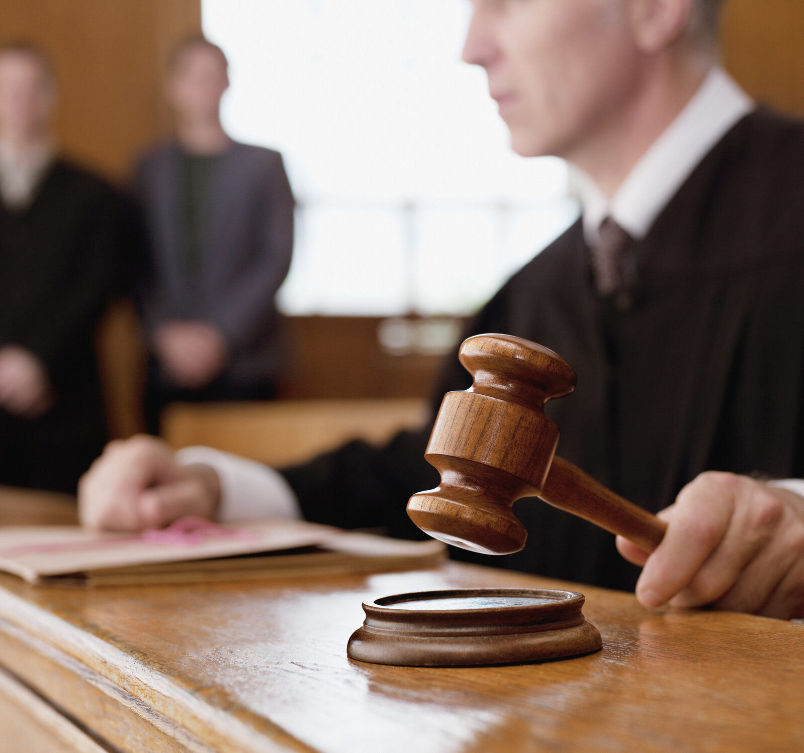 Judge holding gavel in courtroom